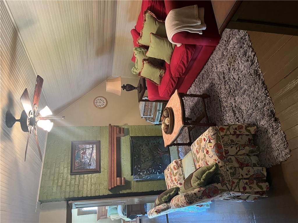 1100 Maple Calvert, TX 77837 - Photo 15 of 31 Living room with a fireplace, a ceiling fan, hardw