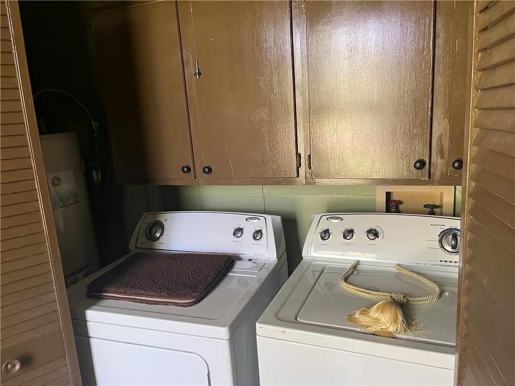 1100 Maple Calvert, TX 77837 - Photo 24 of 31 Laundry area with cabinet space and water heater