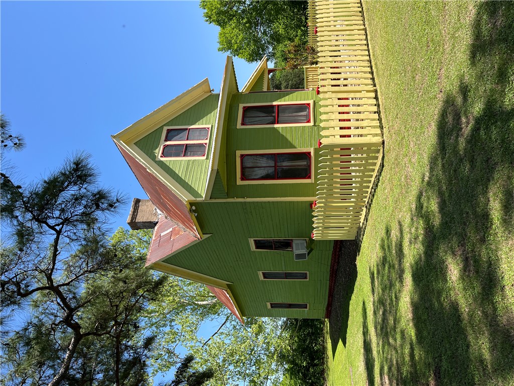 1100 Maple Calvert, TX 77837 - Photo 3 of 31 View of home's exterior with lawn, metal roof, fence, and chimney