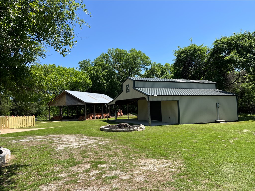 1100 Maple Calvert, TX 77837 - Photo 6 of 31 View of yard featuring an outdoor fire pit, a pole building, a detached carport