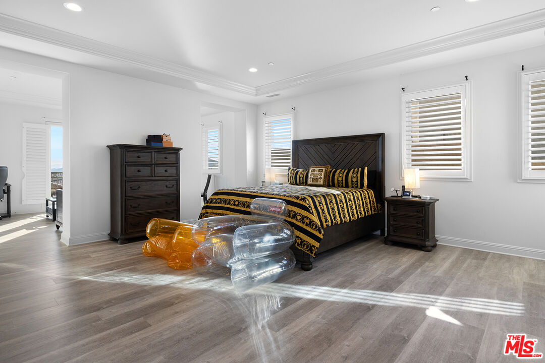 20234 Jubilee Way Porter Ranch, CA 91326 - Photo 18 of 30 a bedroom with a bed and wooden floor