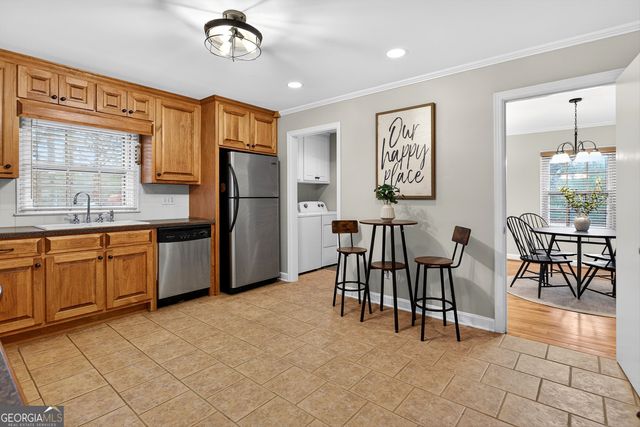 a kitchen with stainless steel appliances granite countertop a refrigerator and a stove top oven
