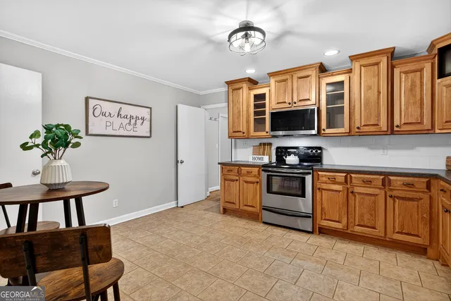 a kitchen with stainless steel appliances granite countertop a stove top oven a sink dishwasher and a microwave oven on the blue kitchen countertops