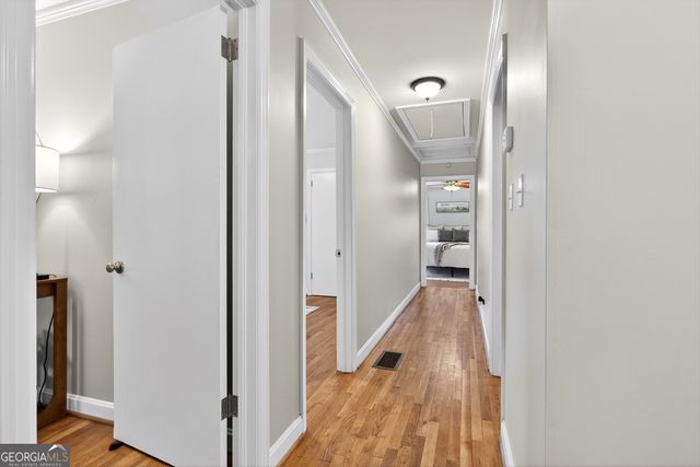 a view of a hallway with wooden floor and staircase