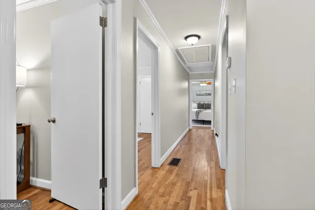 a view of a hallway with wooden floor and staircase