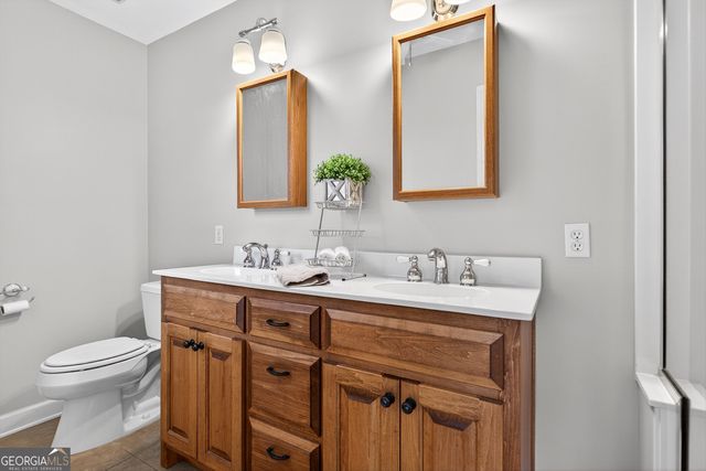 a bathroom with a sink a toilet and mirror