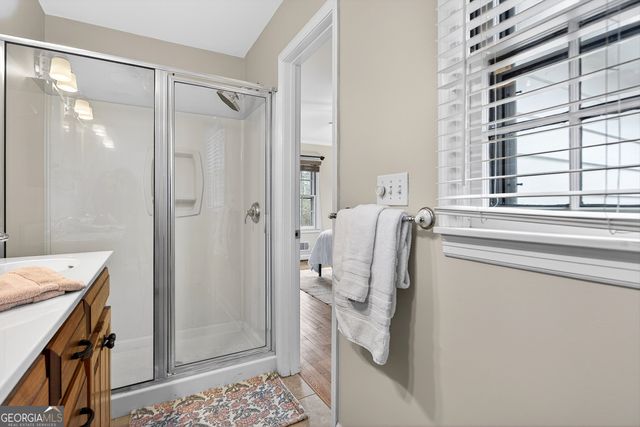 a bathroom with a shower sink and mirror