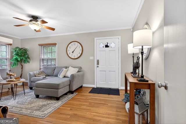 a living room with furniture and a mirror