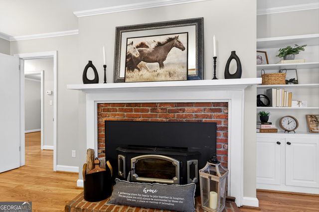 a living room with a fireplace and a wooden floor