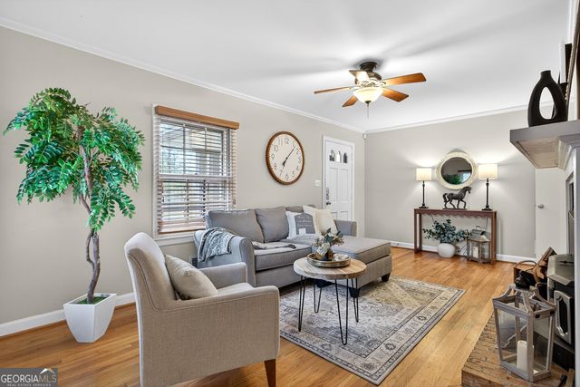 a living room with furniture a chandelier and a window
