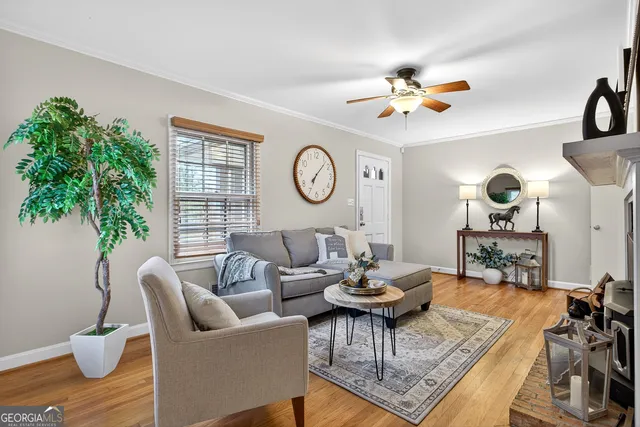 a living room with furniture a chandelier and a window