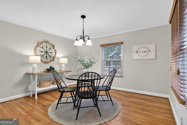 a view of a dining room with furniture wooden floor and chandelier