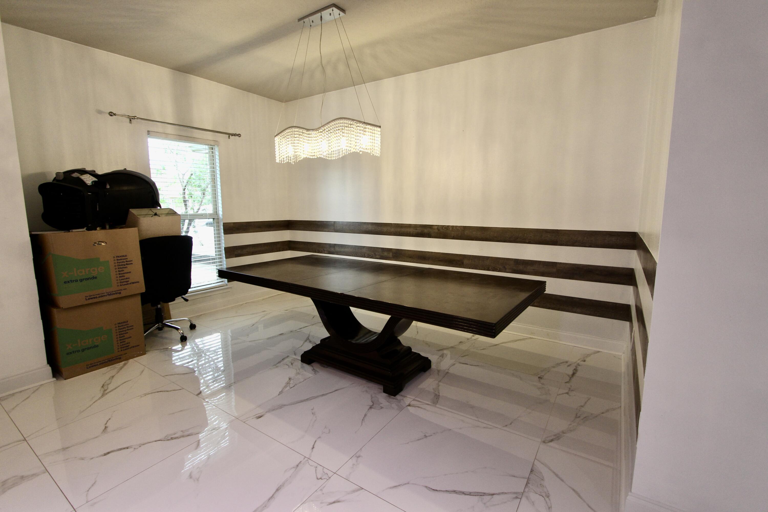 4641 Chanan Drive Crestview, FL 32539 - Photo 12 of 45 a room with table chair and wooden floor