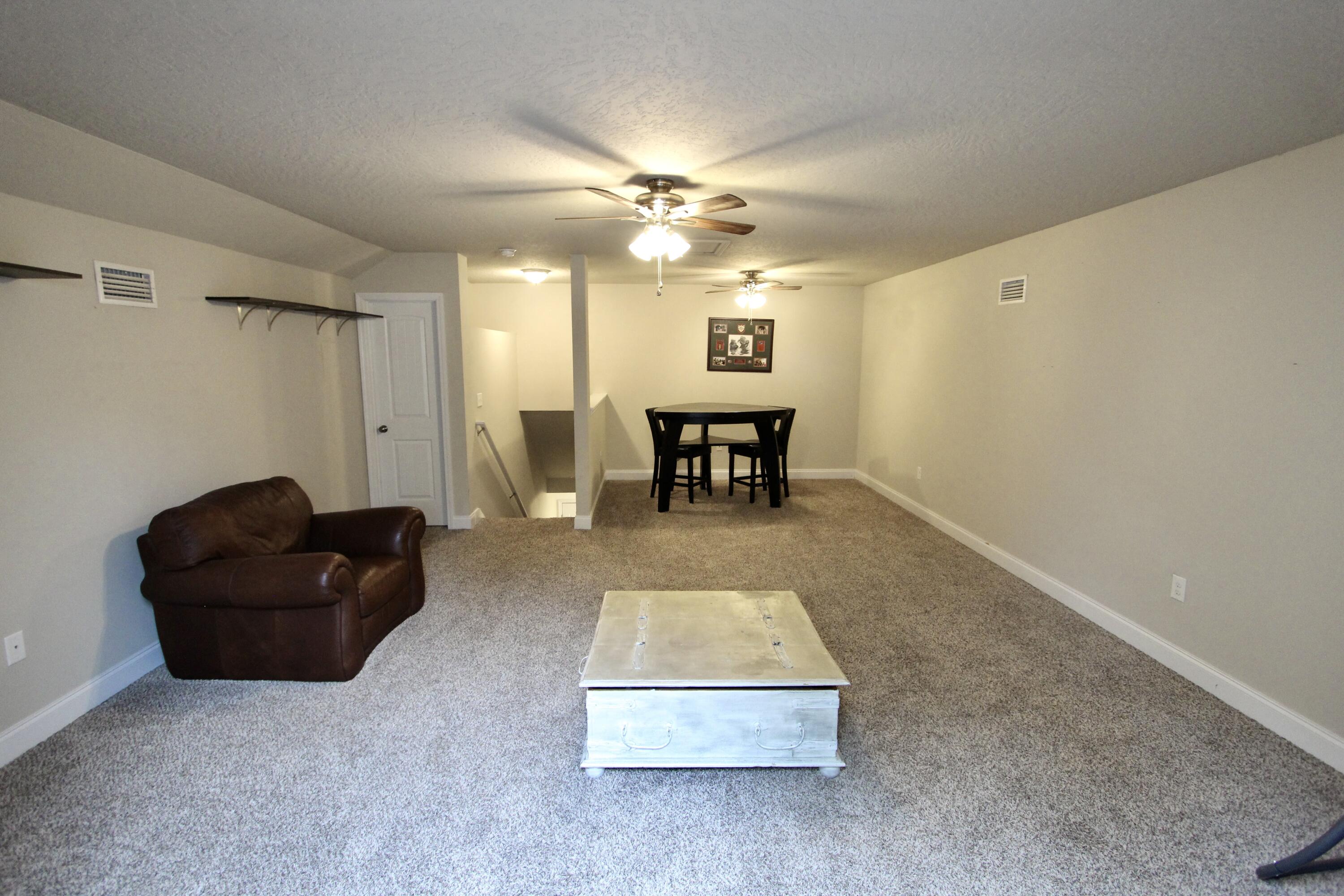 4641 Chanan Drive Crestview, FL 32539 - Photo 19 of 45 a living room with furniture and a table