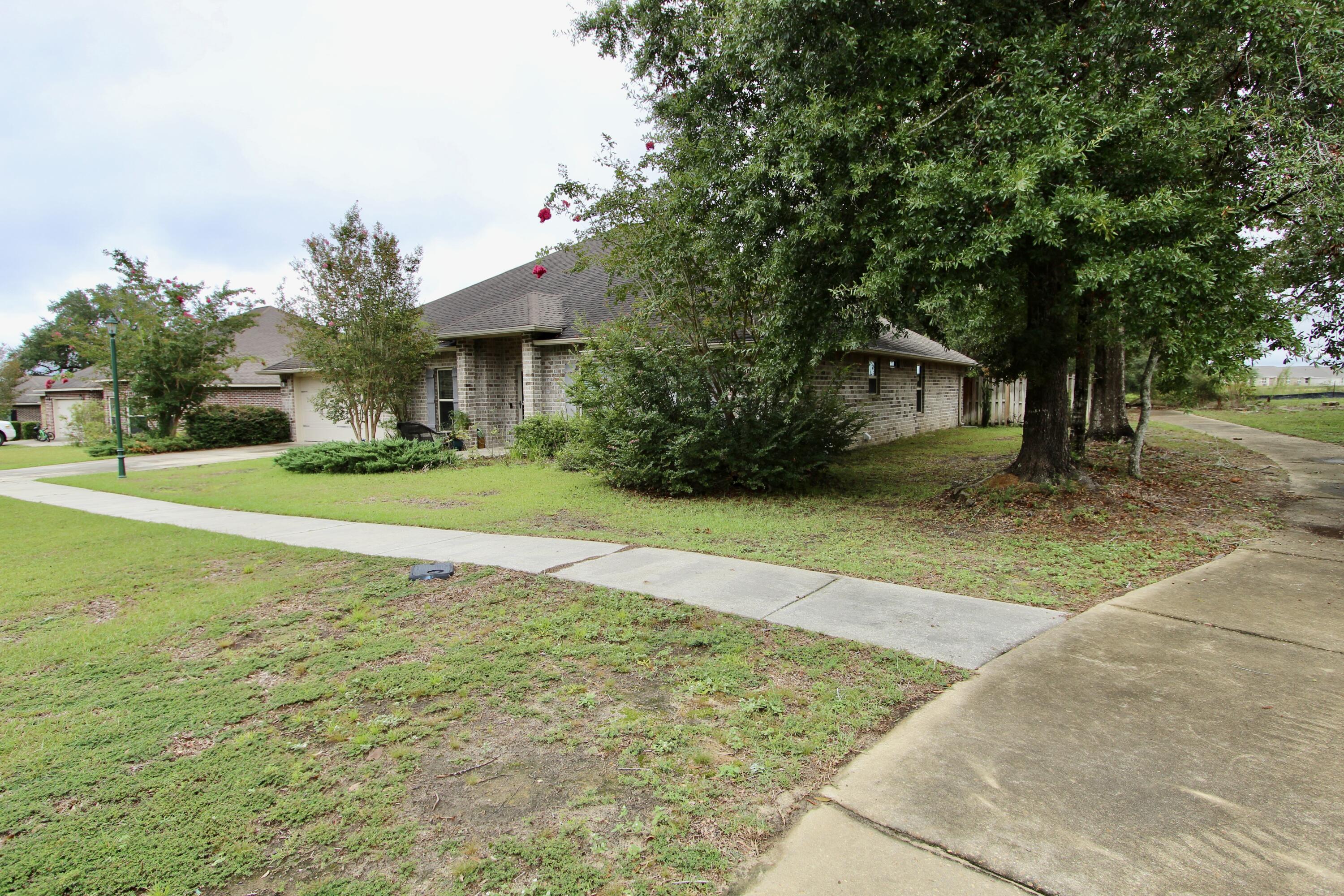 4641 Chanan Drive Crestview, FL 32539 - Photo 2 of 45 a view of a house with a yard and tree s