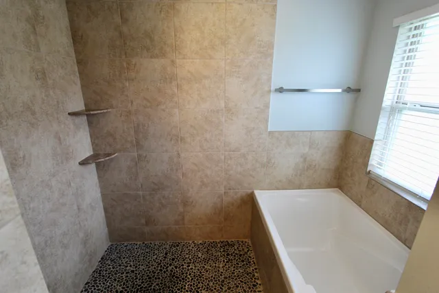 a room with a window and a flat screen tv