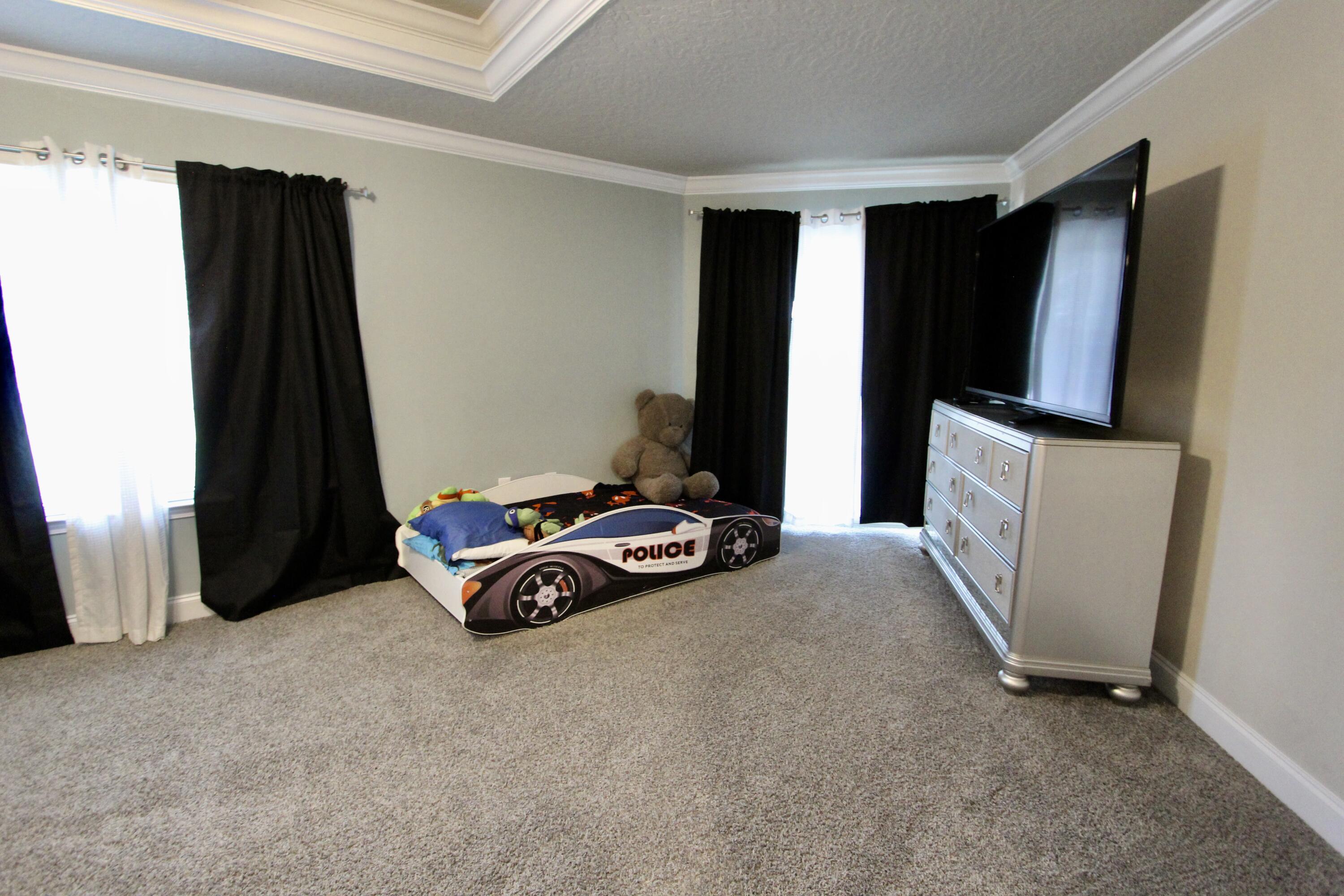 4641 Chanan Drive Crestview, FL 32539 - Photo 23 of 45 a room with a window and a flat screen tv