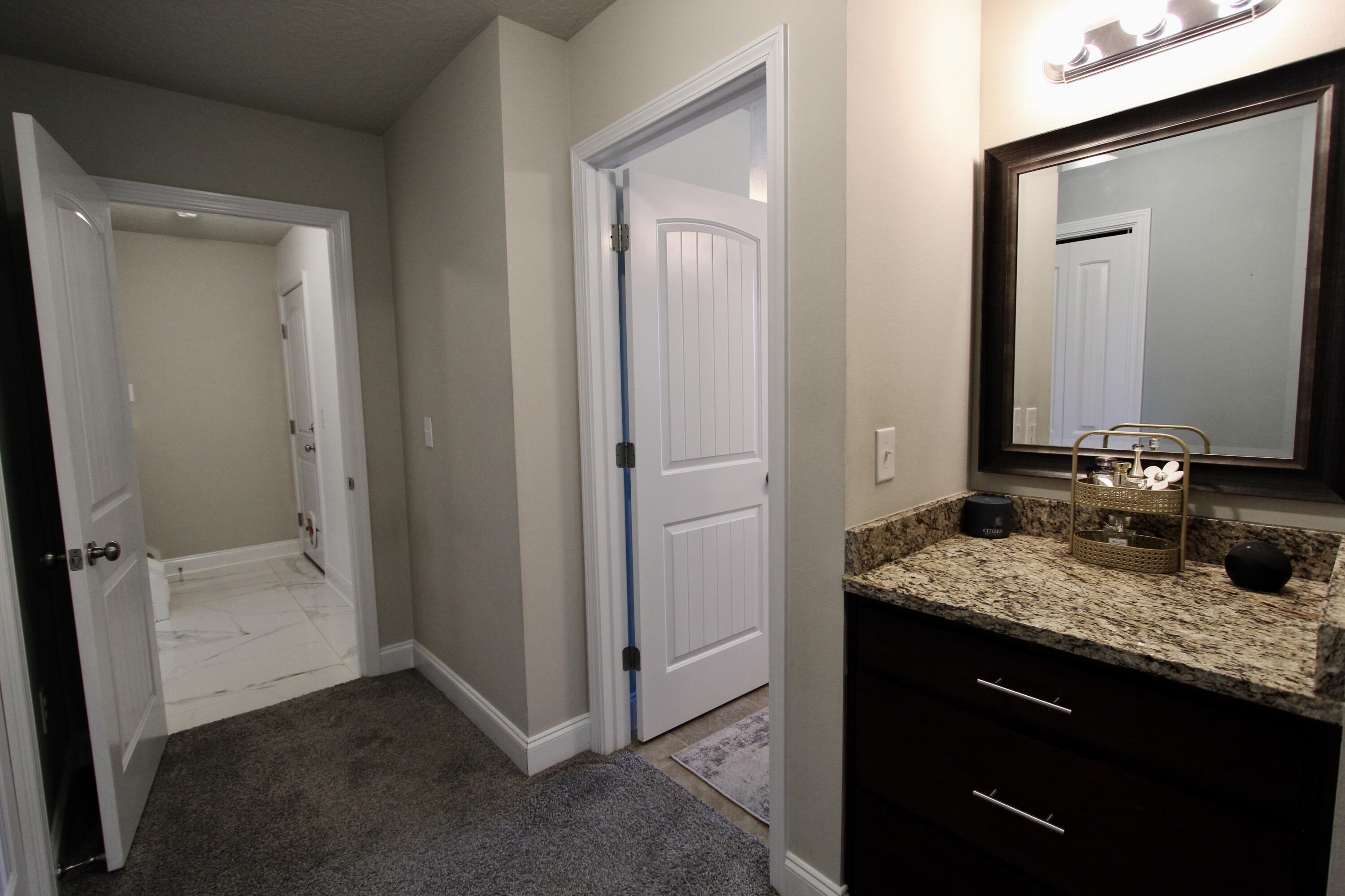 4641 Chanan Drive Crestview, FL 32539 - Photo 26 of 45 a bathroom with a granite countertop sink and a mirror