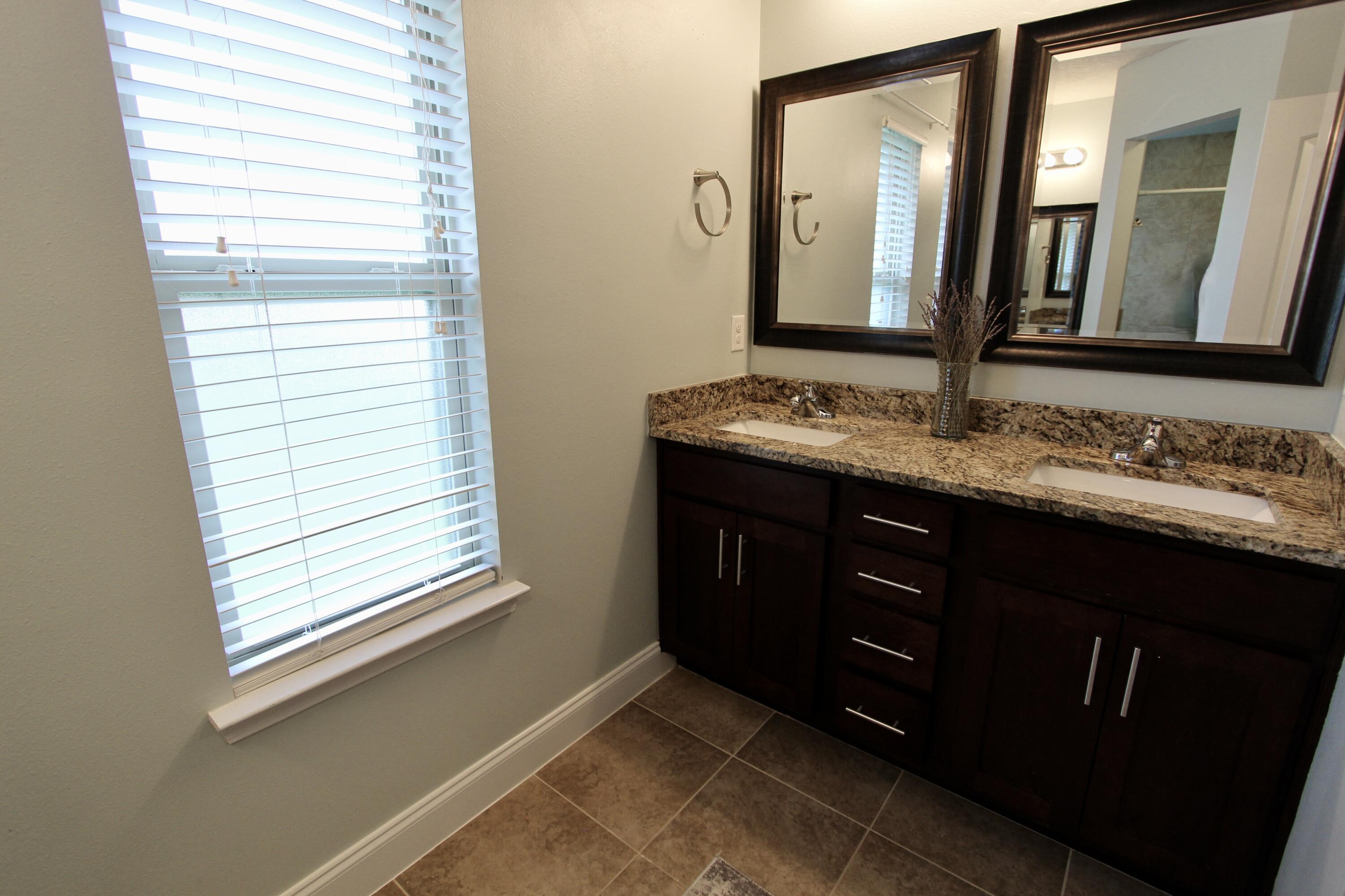 4641 Chanan Drive Crestview, FL 32539 - Photo 28 of 45 a bathroom with a sink and a mirror