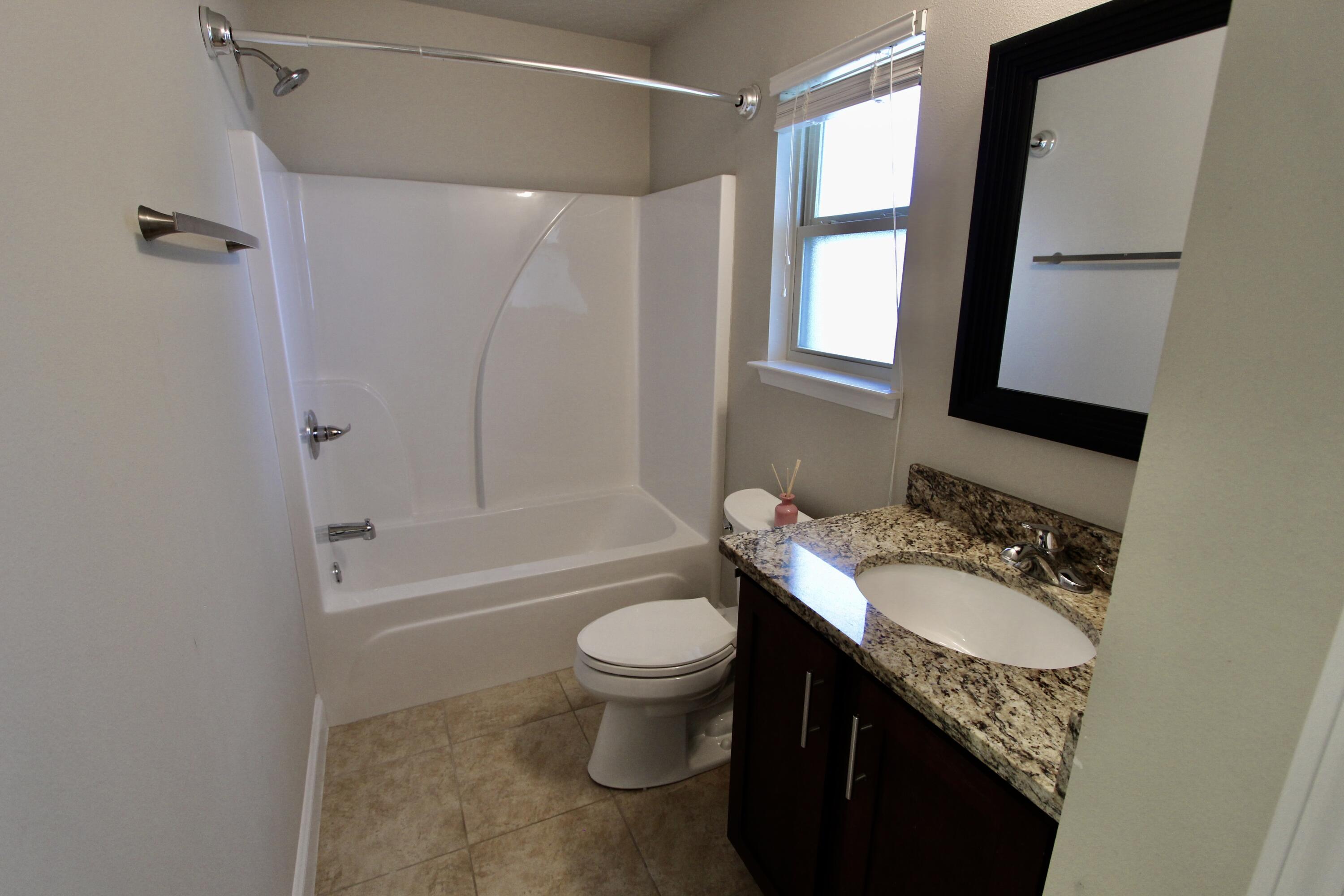 4641 Chanan Drive Crestview, FL 32539 - Photo 29 of 45 a bathroom with a granite countertop sink toilet and shower