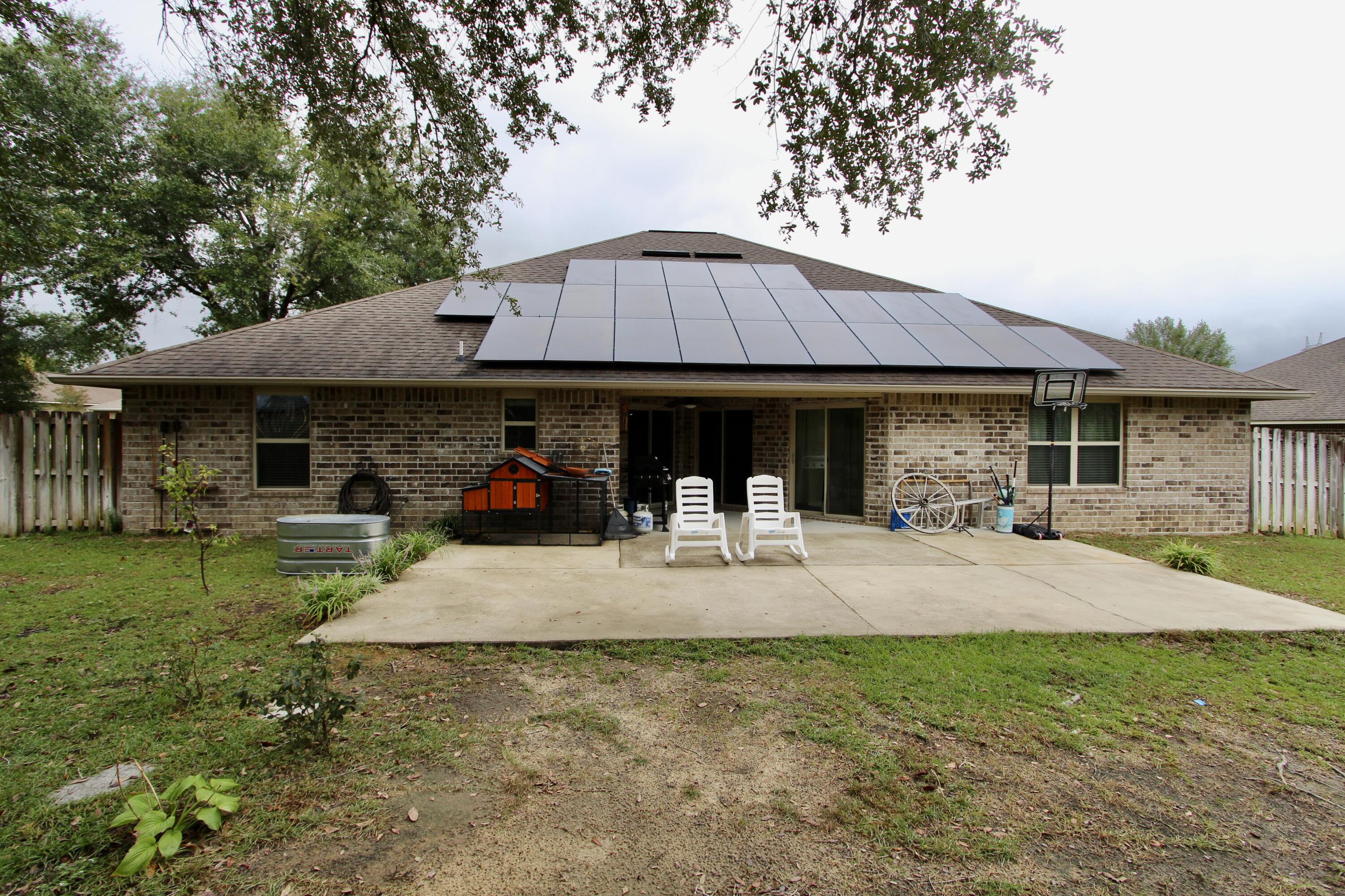 4641 Chanan Drive Crestview, FL 32539 - Photo 40 of 45 a view of a house with a patio and a garden