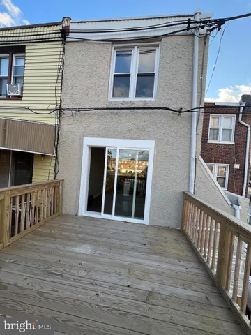a view of a brick house with large windows