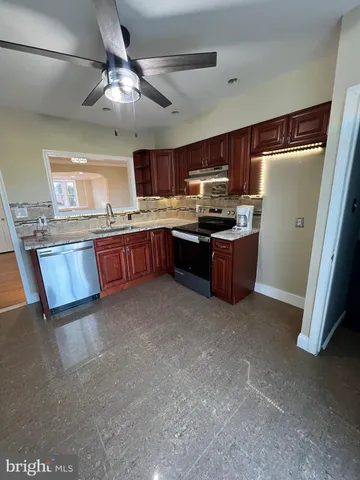 a large kitchen with cabinets and stainless steel appliances