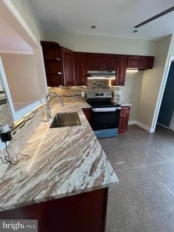 a kitchen with a sink and a stove top oven