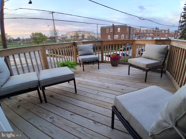 7975 Provident Street Philadelphia, PA 19150 - Photo 22 of 23 a balcony with wooden floor outdoor seating and city view