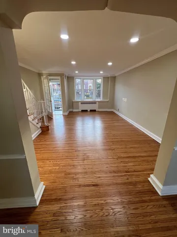 a view of a room with wooden floor