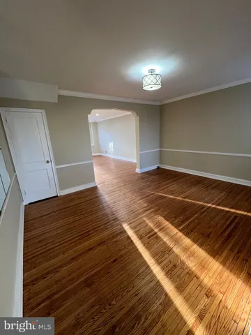 a view of a room with wooden floor and window