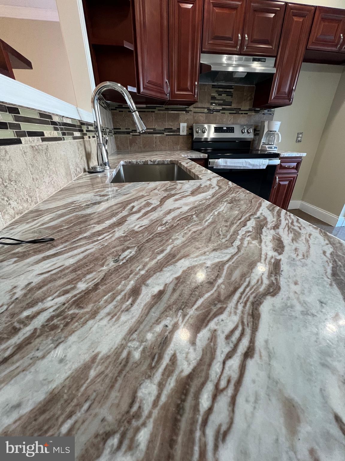 7975 Provident Street Philadelphia, PA 19150 - Photo 9 of 23 a kitchen with a sink and cabinets