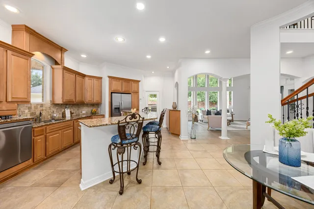a large kitchen with lots of counter space and dining table