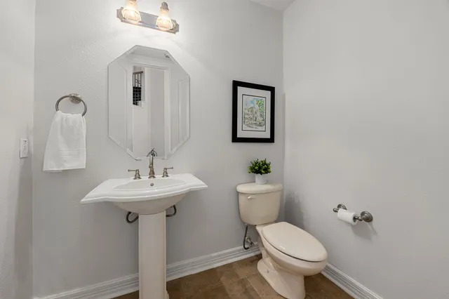 a utility room with mirror and a sink