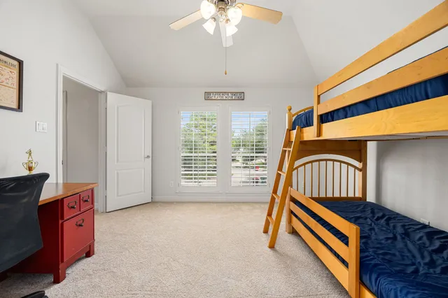 a bedroom with bunk bed and a desk