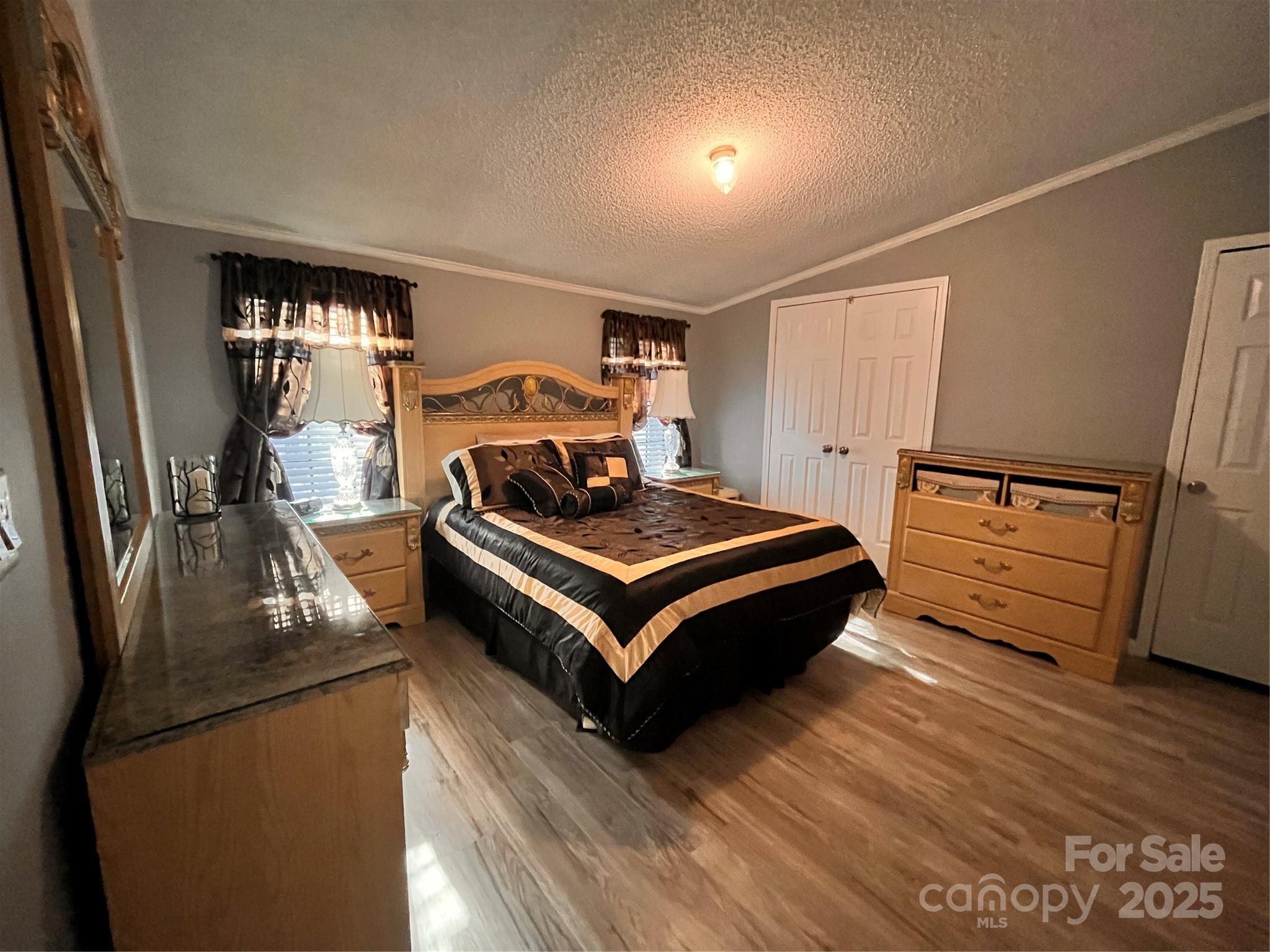 203 Shane Drive Mount Holly, NC 28120 - Photo 14 of 28 a bedroom with a bed and wooden floor