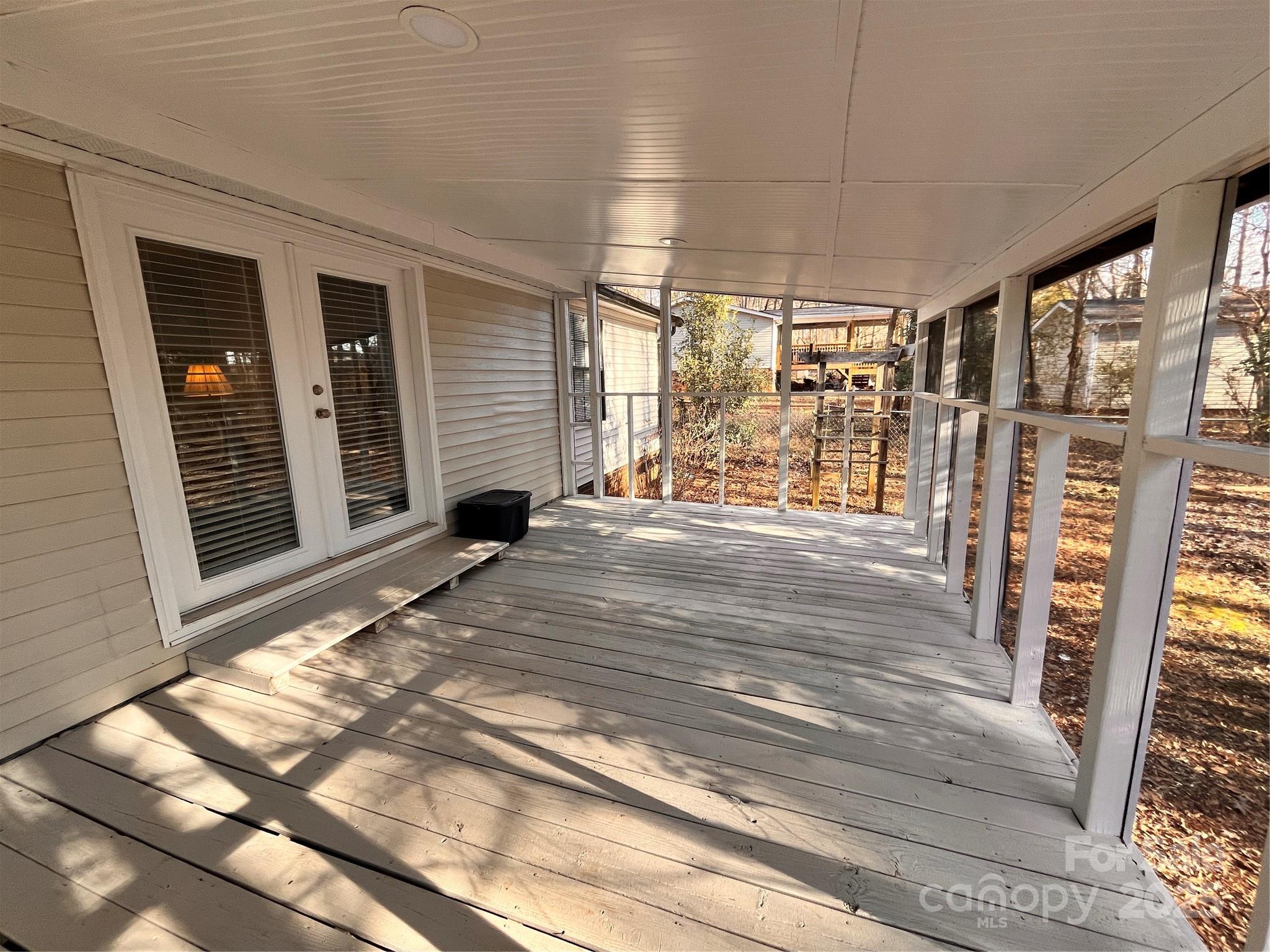 203 Shane Drive Mount Holly, NC 28120 - Photo 20 of 28 a view of a porch with wooden floor and fence