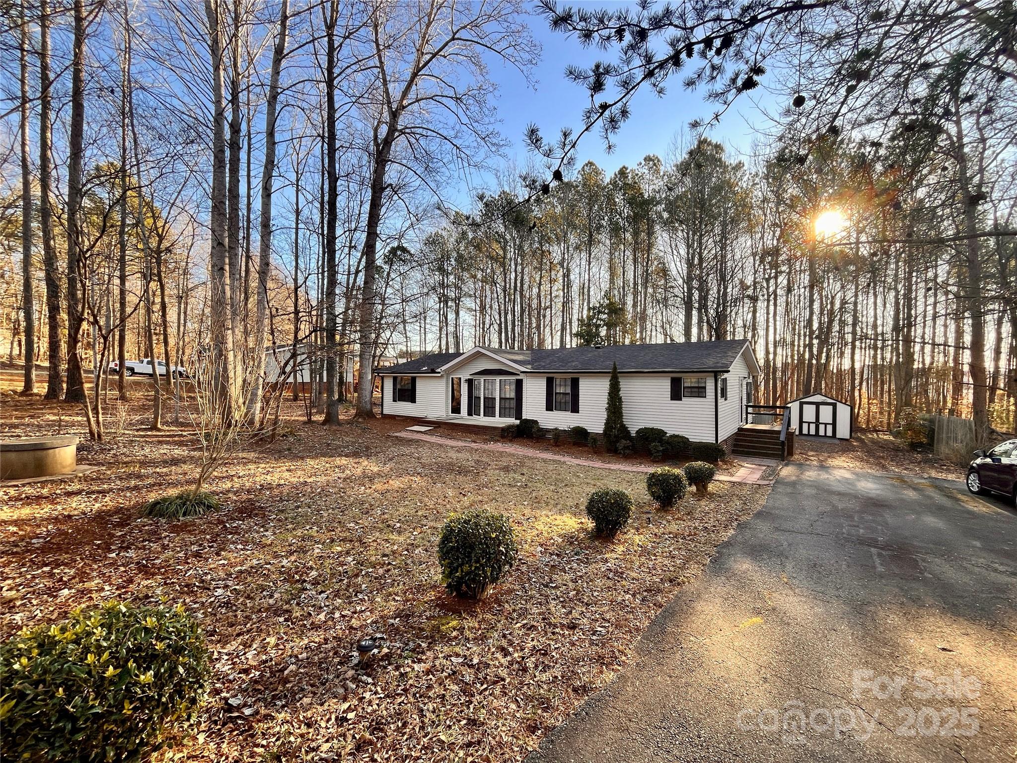 203 Shane Drive Mount Holly, NC 28120 - Photo 2 of 28 a view of a house with a yard covered with snow in the background