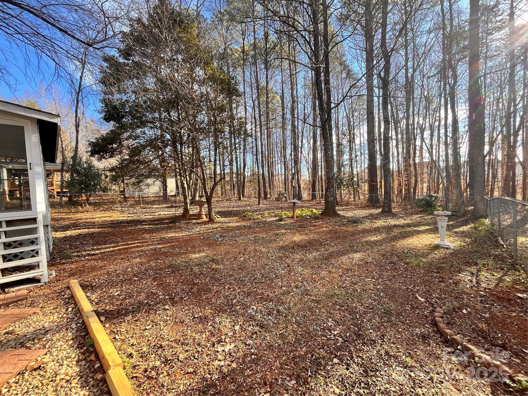 203 Shane Drive Mount Holly, NC 28120 - Photo 24 of 28 a view of outdoor space with deck and trees