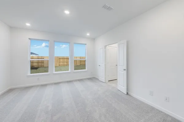 an empty room with a empty space and windows