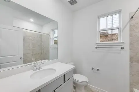 a bathroom with a sink toilet and a mirror