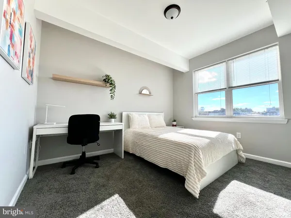 a bedroom with a bed chair and window