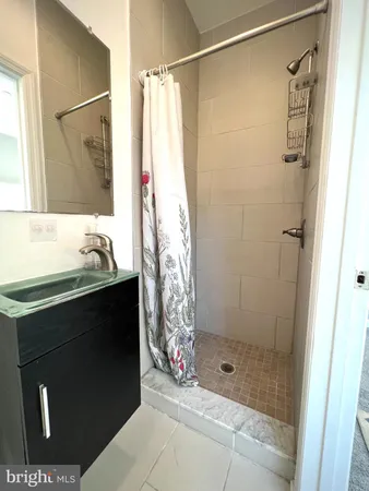 a bathroom with a shower and a sink