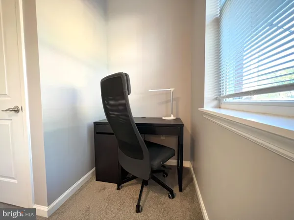 a workspace with furniture and a window