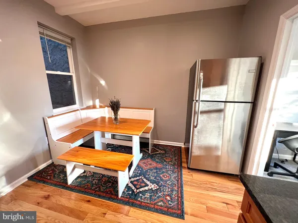 a kitchen with a refrigerator and a stove top oven