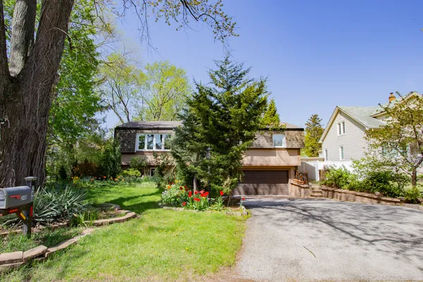 a front view of a house with a yard and a garage