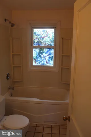 a bathroom with sink toilet and shower