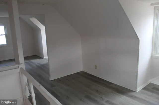 an empty room with wooden floor