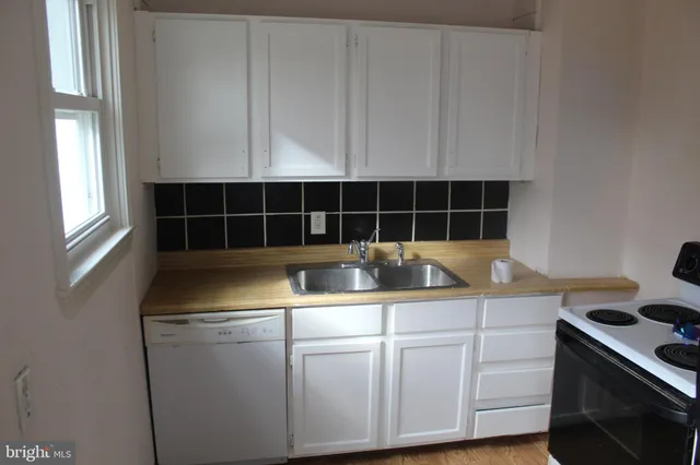 a kitchen with a sink and cabinets