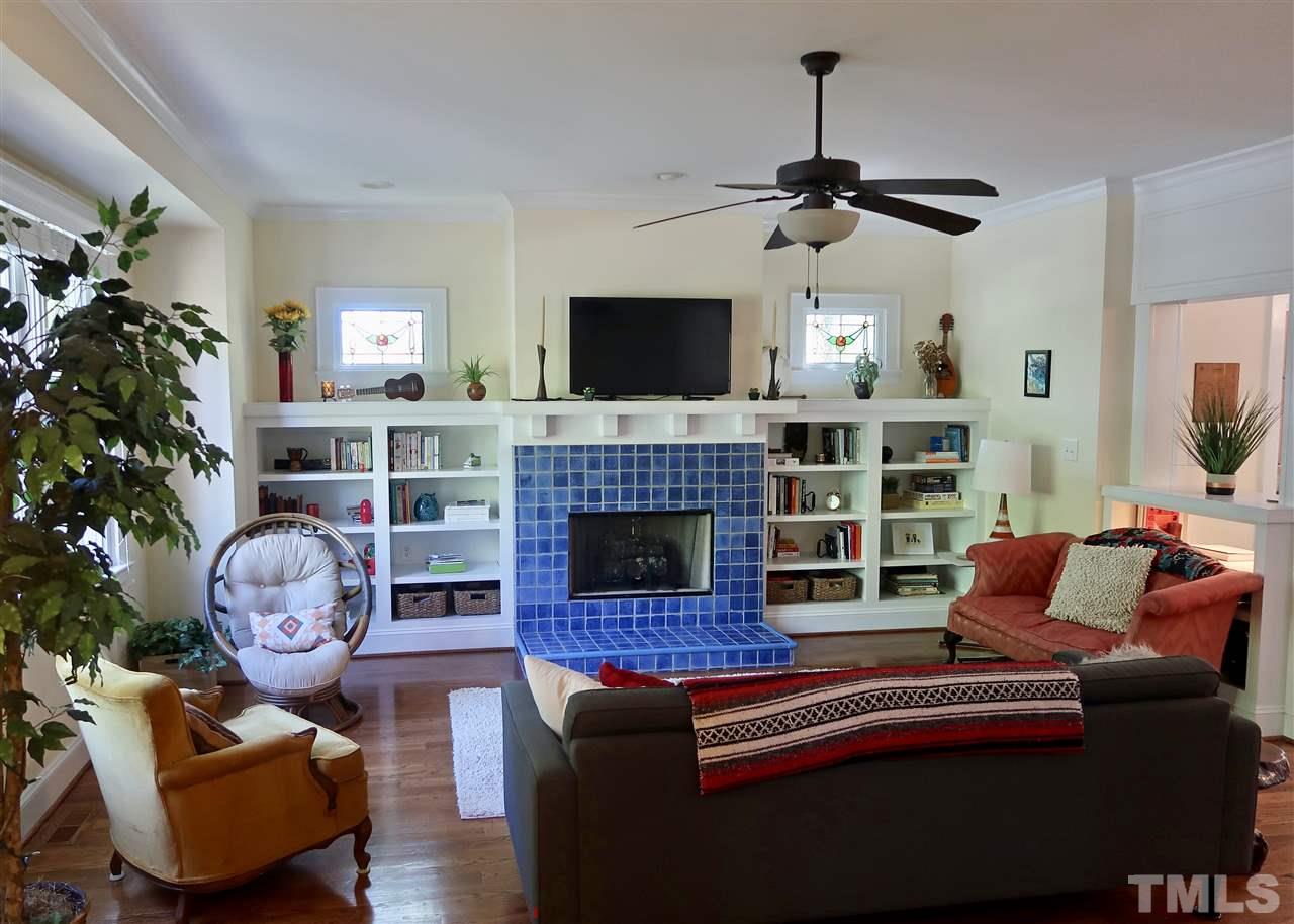 2815 Van Dyke Avenue Raleigh, NC 27607 - Photo 5 of 30 Built ins and Stained glass windows on either side of the vibrant fireplace - which is a focal point of this cozy family room!